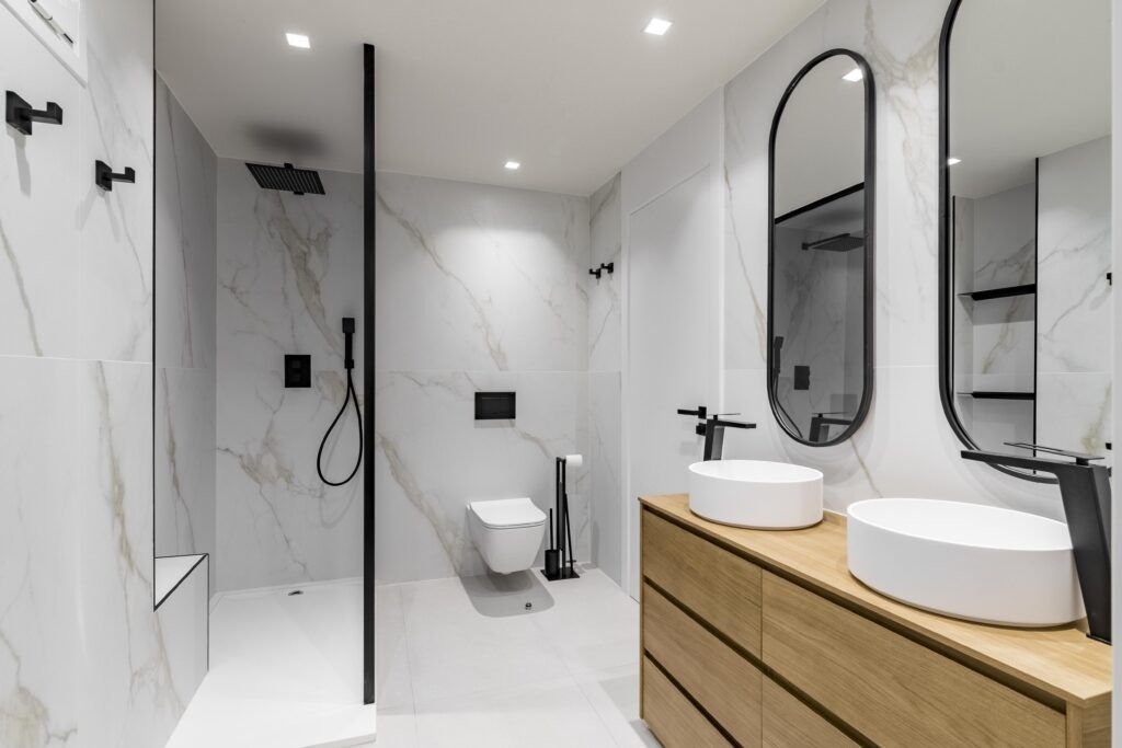 Bright marble walk-in shower with double vanity