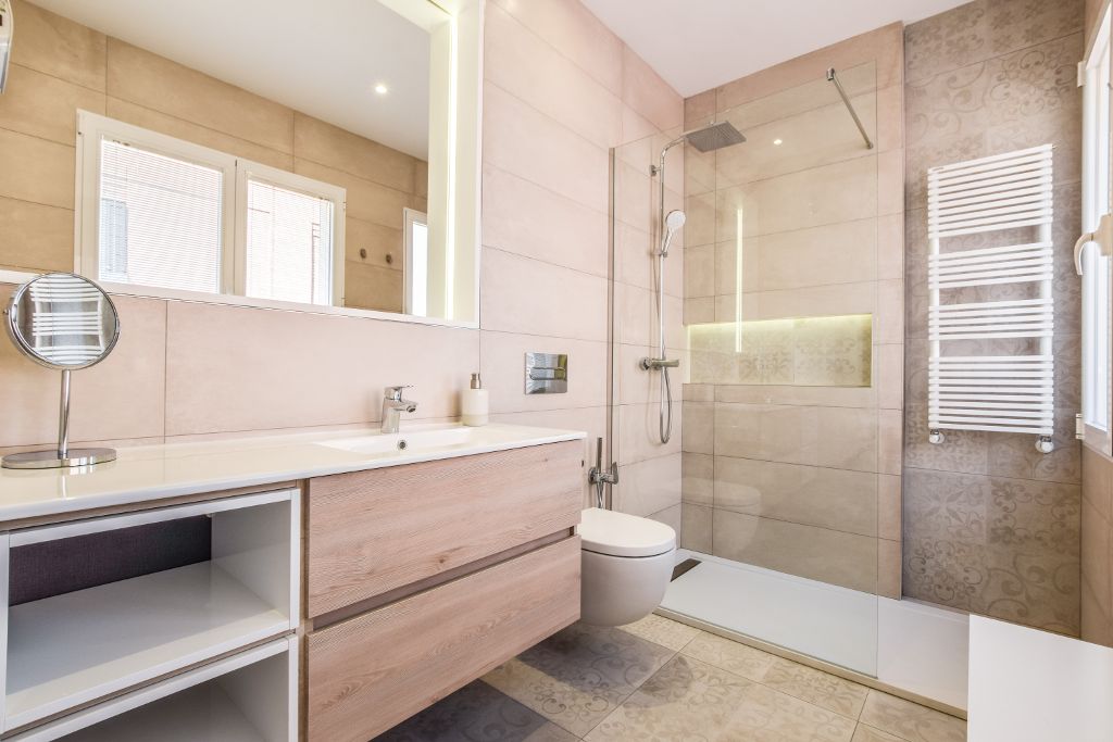 Walk-in shower with heated towel rail and warm tile