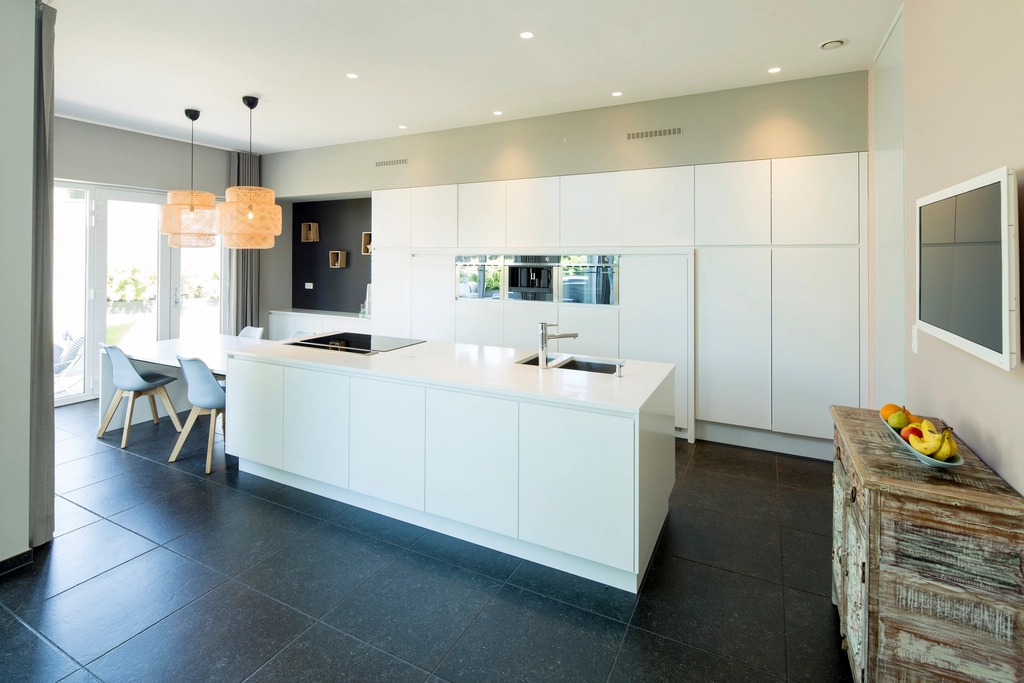 Modern white kitchen island with open dining area